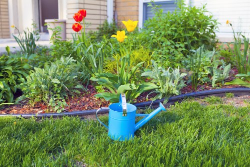 Gardener discussing complaint procedure with client beside a garden bed