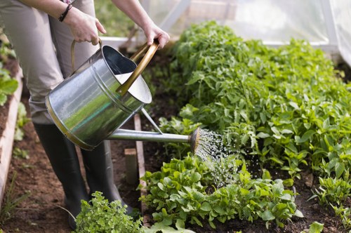Gardener wearing full PPE operating equipment safely in a residential garden